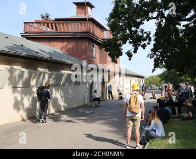 Weimar, Deutschland. September 2020. Die Teilnehmer eines gedenkmarsches stehen vor dem Lagertor des ehemaligen Konzentrationslagers Buchenwald. Anlässlich des 75. Jahrestages der Befreiung des Konzentrationslagers Buchenwald wurde hier der 'Spaziergang nach Buchenwald' veranstaltet. Kredit: Bodo Schackow/dpa-Zentralbild/dpa/Alamy Live Nachrichten Stockfoto