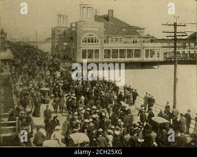 . Baltimore & Ohio Resorts und Quellen, Sommer 1905 . HE ESPLANADE OH • ATLANTIC CITV. Zwölfhundert Hotels und Hütten, die der tran-sient Bevölkerung gewidmet sind. Einige von ihnen sind so großartig indetail wie kann foun&lt;l in dem Land sein. Die Reichen können findluxur- in seiner reichsten Form, und die bescheidenen können weniger protzig Quartiere zu beschaffen und comfortablv provided für. Die herrliche Esplanade, oder Promenade, ist frei zu allen, reichen und armen gleich; und der herrliche Badestrandmacht keinen Unterschied unter seinen Badenden. Der Boardwalkist fünf Meilen lang und reicht von der südlichen Ex-Tremity von Stockfoto