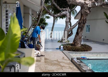 Meister putzen die Klimaanlage in einem tropischen Hotel. Stockfoto