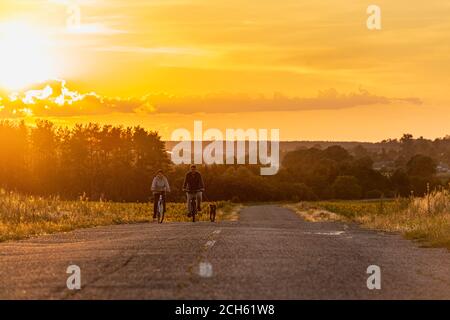 2020-07-15 Bucha, Ukraine. Glückliches Paar mittleren Alters auf einer Radtour mit ihrem Hund. Sommerurlaub Stockfoto