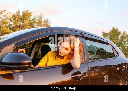Gestresste junge Frau, die im Auto sitzt Stockfoto