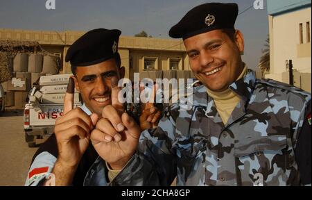 Offiziere der irakischen Polizei stimmen am Donnerstag, den 15. Dezember 2005, bei As Samawah in der irakischen Provinz Al Muthanna ab. Die Wahlen im Irak begannen heute reibungslos, als die Iraker zum ersten Mal unter ihrer neuen Verfassung an die Urnen gingen. In Wahllokalen in der Provinzhauptstadt Amara kam ein stetiger Strom von Menschen an, um ihre Stimmen abzugeben. Die britische Armee hat die Patrouille für den Tag fast völlig ausgesetzt, um deutlich zu machen, dass sie nicht versuchen, das Ergebnis in irgendeiner Weise zu beeinflussen. Aber der Oberbefehlshaber in der Provinz, Oberstleutnant Ben Edwards vom königlichen Schotten Dragoon Gu Stockfoto