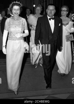 Ein königliches Lächeln, als Königin Elizabeth II. In der Guildhall in London ankommt, um an einem Empfang anlässlich des 100. Jahrestages der Pressevereinigung, der nationalen Nachrichtenagentur Großbritanniens, teilzunehmen. Mit der Königin ist der Vorsitzende der PA, W.D. Barnetson. Stockfoto