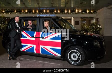 Mike Hawes, CEO von SMMT, Tony Walker, Präsident von SMMT und Komikerin Jennifer Saunders kommen beim jährlichen Dinner der Society of Motor Manufacturers and Traders (SMMT) an, um die Automobilindustrie im Grosvenor House Hotel, London, zu feiern. Stockfoto