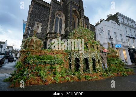 NUR FÜR REDAKTIONELLE VERWENDUNG Pflanzenexperte, Tomoko O'Reilly bringt den letzten Schliff zu einer 12 Fuß großen Nachbildung des Brighton Pavilion aus Pflanzen, Erstellt von Seventh Generation und Plantlife in Brighton, um Menschen zu ermutigen, eine Online-Petition zu unterzeichnen, die die Regierung auffordert, mehr in pflanzenbasierte Lösungen zur Bekämpfung des Klimawandels zu investieren. Stockfoto