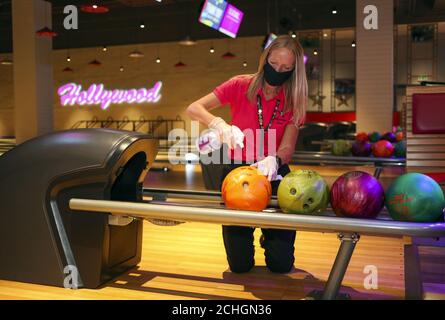 GESPERRT BIS 0001 DIENSTAG 16. JUNI EIN Mitarbeiter der Hollywood Bowl in Thurrock, Essex, reinigt die Bowling-Bälle. Eine von mehreren potenziellen Maßnahmen zur Arbeitssicherheit, die in Erwartung zukünftiger Leitlinien der britischen Regierung hinsichtlich der Wiedereröffnung von Freizeitunternehmen ergriffen werden. Stockfoto