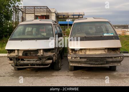 Stehen Sie in der Nähe auf der Straße zwei halb zerlegte Minibusse Stockfoto