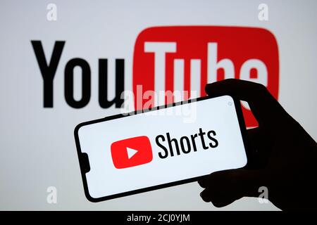 Stafford / UK - September 14 2020: Youtube Shorts app logo seen on the silhouette of smartphone in a hand. It is a new short looping video platform. R Stock Photo