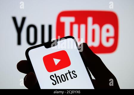 Stafford / UK - September 14 2020: Youtube Shorts app logo seen on the silhouette of smartphone in a hand. It is a new short looping video platform. R Stock Photo