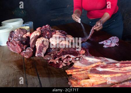 Frau salzen Fleisch für 'Shisenyama' (Grill), Johannesburg, Südafrika Stockfoto