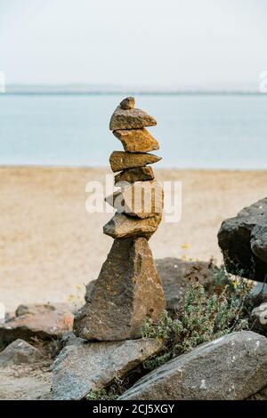 Gestapelte Kieselsteine am Strand bei Sonnenuntergang, Morro Bay State Park, Kalifornien Stockfoto