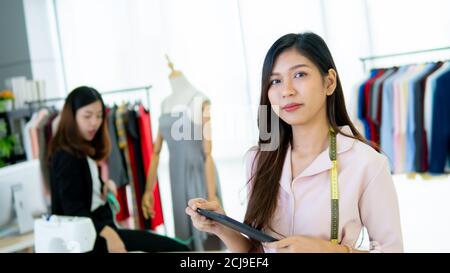 Porträt von Asien junger Designer, der im Bekleidungsgeschäft arbeitet Stockfoto