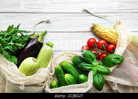 Frisches Gemüse in Öko-Baumwolltüten auf dem Tisch in der Küche. Frisches Gemüse vom Markt. Zero Waste Shopping-Konzept. Stockfoto