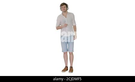 Lässiger junger Mann, der Musik lauscht und Kopfhörer an sich hält Ha Stockfoto