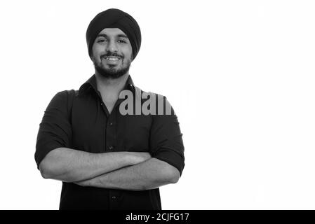 Porträt eines glücklichen jungen bärtigen indischen Sikh Geschäftsmann mit Turban Stockfoto