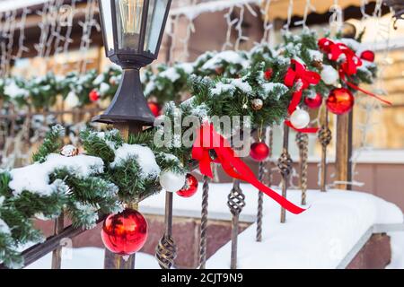 Weihnachten Stadtbild - Dekoration Geländer Veranda am Vorabend des Urlaubs. Weihnachtskugeln und Bänder. Winterurlaub. Stockfoto