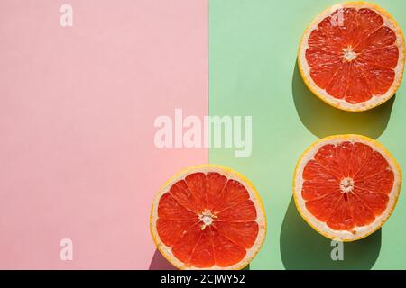 Bunte frische Zitrusfrüchte auf pastellfarbenem Hintergrund. Blutorange, Grapefruit. Obst Hintergrund. Sommerliches Food-Konzept. Gesunde vegetarische Bio-Lebensmittel Stockfoto