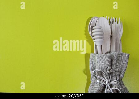 Umweltfreundliche Einweg-Utensilien aus Bambusholz auf gelbem Hintergrund. Zero Waste Konzept. Draufsicht. Speicherplatz kopieren. Stockfoto