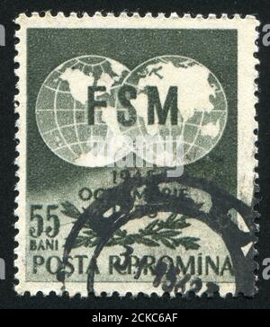 RUMÄNIEN - UM 1955: Briefmarke gedruckt von Rumänien, zeigt Globen und Olivenzweige, um 1955 Stockfoto