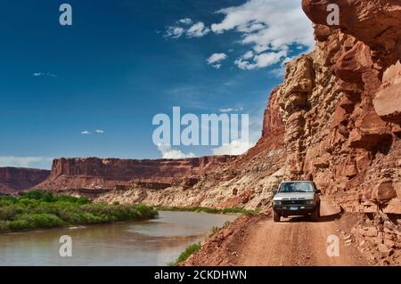 4WD Fahrzeug auf der White Rim Road über den Green River in Labirynth Canyon, Island in the Sky, Canyonlands National Park, Utah, USA Stockfoto
