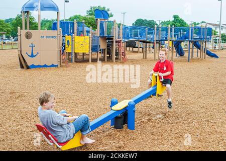 Hampton Virginia, Tidewater Area, Buckroe Beach, Park öffentlicher Spielplatz Wippe mit Reiten auf Jungen Jungen Freunde, Erholung Menschen Person Stockfoto