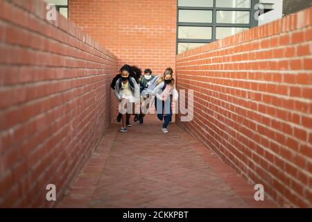 Gruppe von Kindern tragen Gesichtsmaske laufen Stockfoto