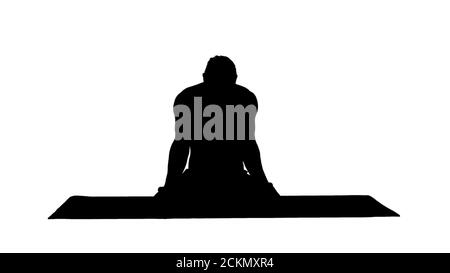 Silhouette junger Mann praktiziert Yoga in Lotusposition. Stockfoto