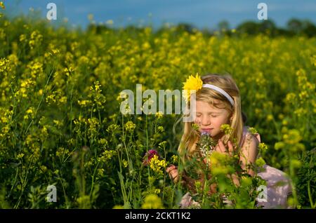 Portrait von schönen blonden Mädchen in Rapsfeld Stockfoto