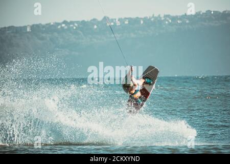 WAKEBOARDING AUF DEM MEER SPRINGEN HOCH MIT EINEM BACKFLIP. Stockfoto