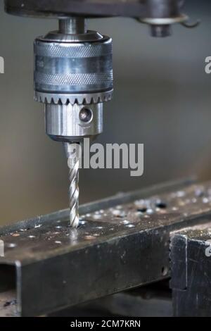 Industrielle Bohrmaschine bohrt ein Loch in das Metall. Metallbearbeitungsmaschinen. Stockfoto