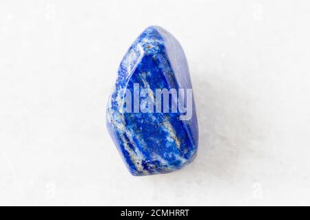 Nahaufnahme der Probe des natürlichen Minerals aus der geologischen Sammlung - Gestromter Lapis Lazuli (Lazurit) Stein auf weißem Marmor Hintergrund aus Afghanistan Stockfoto