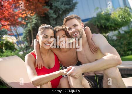 Umarmt Eltern mit ihrem Sohn im Urlaub Stockfoto