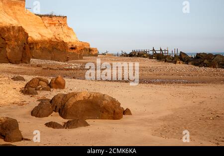 Ein Blick auf erodierende Klippen, Felsenschweller und verfallende Meeresverteidigungen an der Nord-Norfolk-Küste in Happisburgh, Norfolk, England, Vereinigtes Königreich. Stockfoto