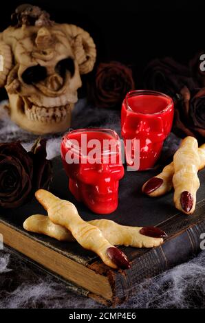 Tauchen Sie knusprige Shortbread-Kekse in Form von Hexenfingern In heißer Schokolade Red Velvet.Dies ist Jus Stockfoto