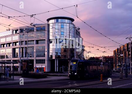 Breslau, Polen. 08/28/2020 Straßenbahn Ankunft an einer Bushaltestelle vor einem modernen Bürogebäude Bema Plaza an Bema Street bei Sonnenuntergang Stockfoto