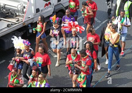 Große Parade von kostümierten Menschen an Nottinghill Karneval in London, Großbritannien Stockfoto