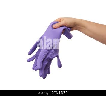 Weibliche Hand hält ein Paar lila Gummihandschuhe für Reinigung des Hauses Stockfoto