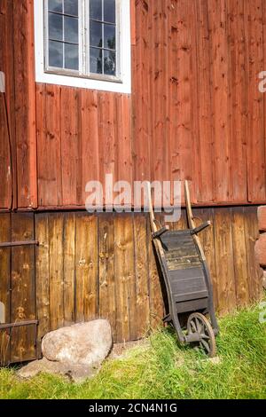 Alte Holzkarre auf einer Bauernmauer Stockfoto