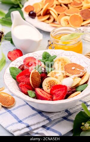 Porridge von winzigen Pfannkuchen mit Beeren. Trendiges Essen. Stockfoto