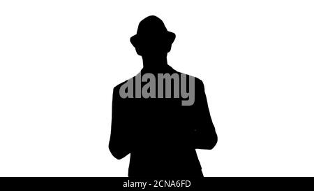 Silhouette Gelegenheitlicher Mann in einem Hut zu Fuß und zeigt digitale Tablette zur Kamera. Stockfoto