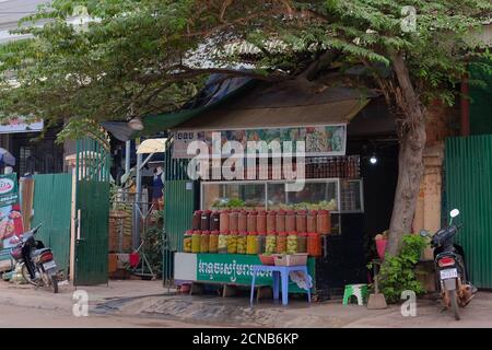 Kambodscha, Siem Reap 12/08/2018 Straßenhandel mit exotischen Gewürzen und Früchten, viele bunte Gläser mit Gewürzen, ein Baum in der Nähe des Kiosks Stockfoto