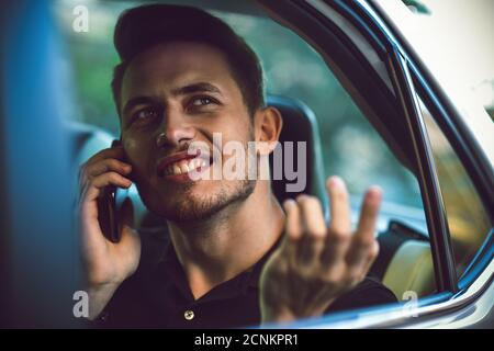 Passagier Geschäftsmann mit einem Smartphone auf dem Rücksitz des Autos. Stockfoto