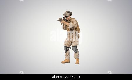 Bewaffneter Marinesoldat mit Sturmgewehr, der mit dem Ziel läuft gra Stockfoto