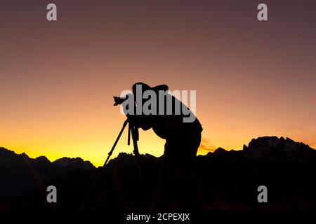 Silhouette der Fotograf Aufnahmen im Berg bei Sonnenaufgang Stockfoto