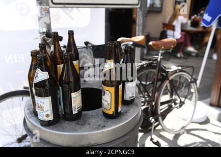 München, Deutschland. September 2020. Bierflaschen stehen auf einer Mülltonne in der Münchner Innenstadt. Trotz der koronabedingten Absage der Wiesn finden in der Landeshauptstadt Veranstaltungen und Aktionen statt. Quelle: Felix Hörhager/dpa/Alamy Live News Stockfoto