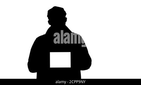 Silhouette Mann in Graben gehen und halten Tablette mit weiß S Stockfoto