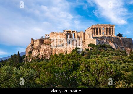 Toller Blick auf den Akropolis-Hügel vom Pnyx-Hügel am Sommertag mit großen Wolken am blauen Himmel, Athen, Griechenland. UNESCO-Weltkulturerbe. Propylaea, Parthenon. Stockfoto