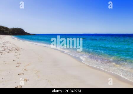 Fußabdrücke auf unberührten weißen Sandstränden des Strandes von CHinamans in der Bucht von Jervis an einem sonnigen Sommertag. Stockfoto