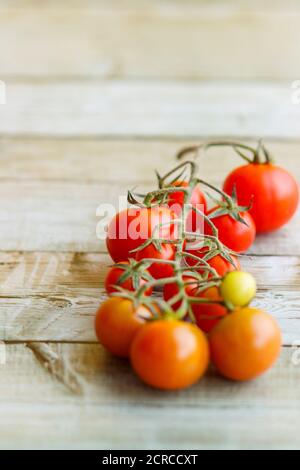 Blick auf schöne rote Kirschtomaten auf Holzhintergrund Stockfoto