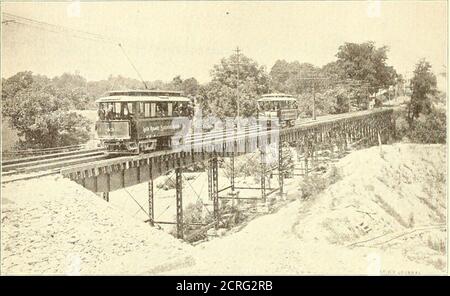 . Die Straßenbahnzeitschrift . Anlage besteht aus zwei 750 h. p. P., Tandem-Verbundmotoren, gebaut von der Corliss Steam Engine Company, von Provi-dence, R. I., die einen einzigen Hauptschacht fahren, von dem vier 400 h. p. Thomson-Houston Generatoren angetrieben werden. Es gibt auch einen 120 h. p. P. Kugelmotor und einen West-Inghouse alternierenden Dynamo für die elektrische Beleuchtung Service von Roland Park.der Kesselraum, der vom Maschinenraum durch eine zwei Fuß Wand abgetrennt ist, -is58 X 100 ft., und enthält sechs VertikalCorliss Kessel achtzig Zoll im Durchmesser. Bei Roland Park sind das Autohaus und die Generalbüros der Firma lo Stockfoto